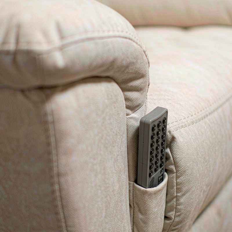 Close-up of the Korser recliner armrest with remote and side pocket