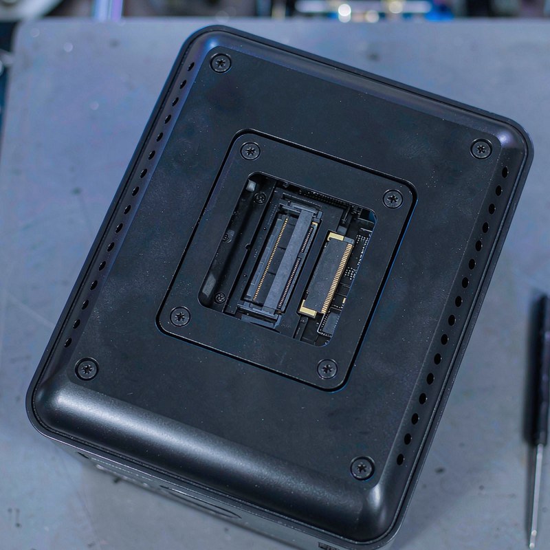 The underside of the GMKtec G10 with its access panel removed showing a memory slot and M.2 SSD.