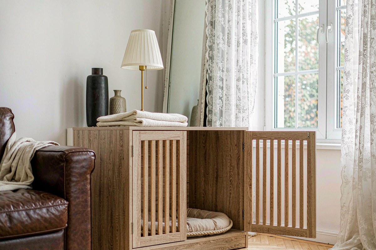 A wooden Garvee dog crate furniture piece used as a side table in a bright living room